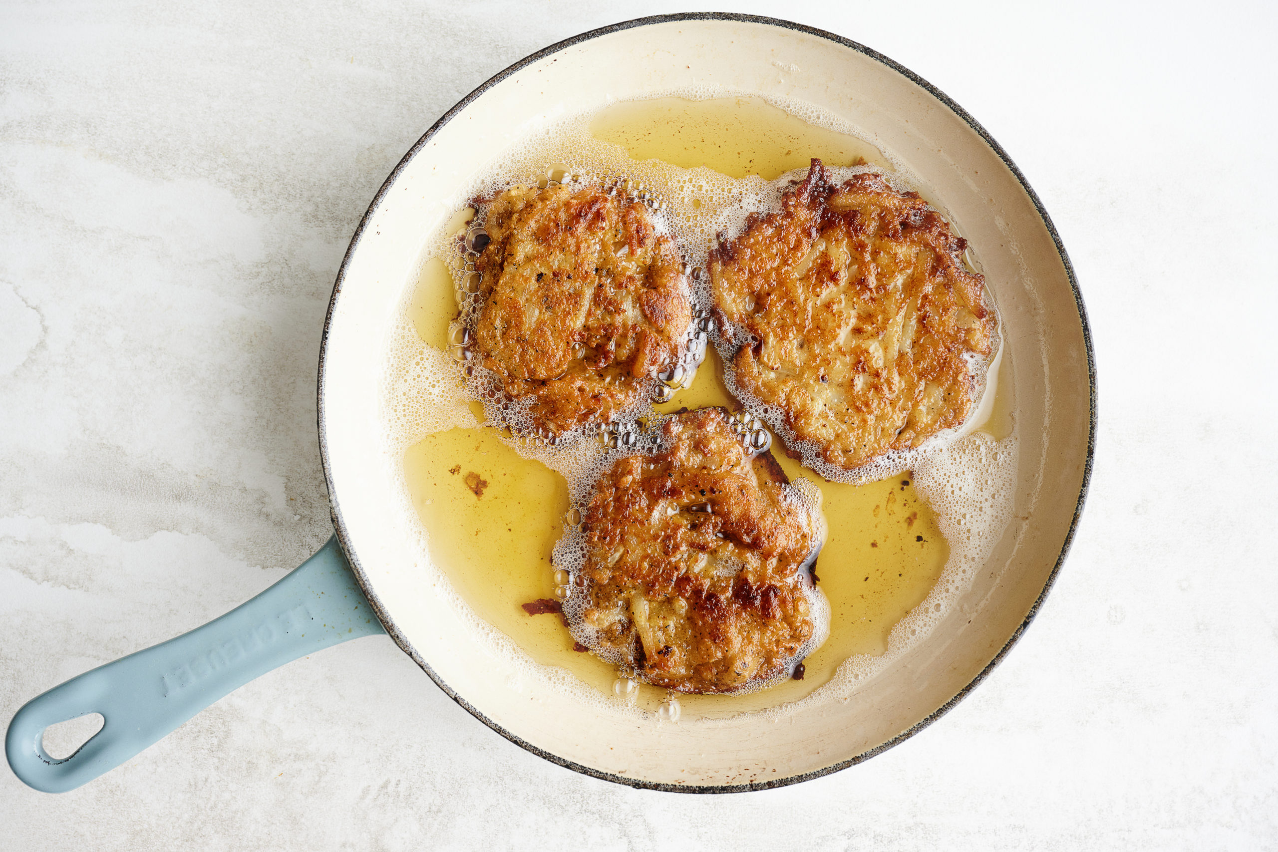 potato latkes in a frying pan