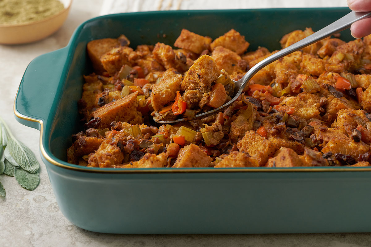 A close-up of Pacific Spice Company's Vegetarian Stuffing Casserole, highlighting the texture and golden crust, with the rich flavor of PSC Sage and Savory Stuffing Seasoning.